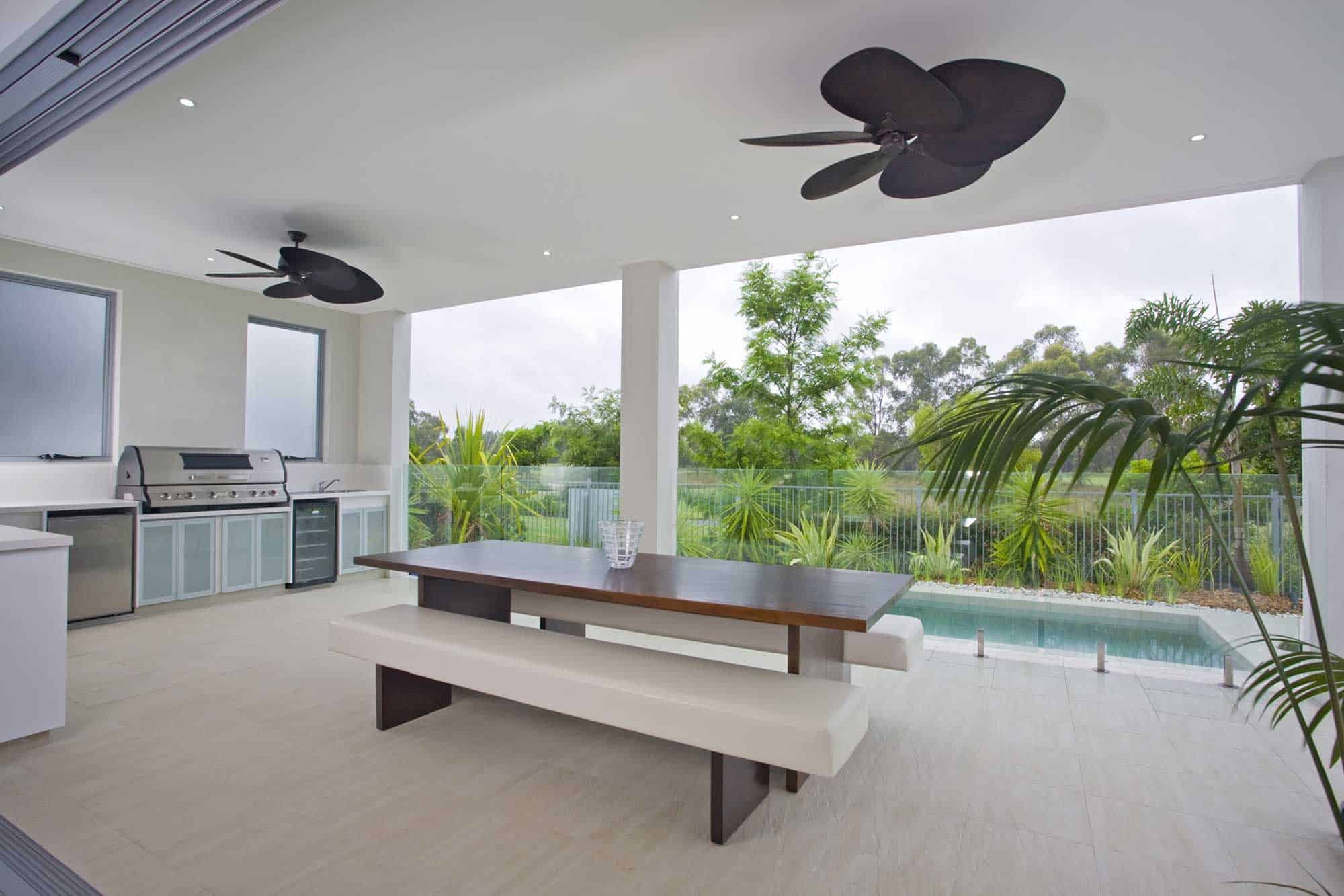 Contemporary outdoor kitchen with dining table