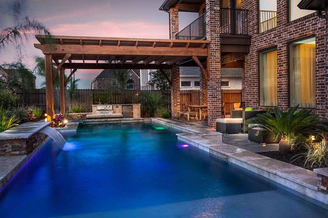 Pergola, pool, waterfall, outdoor kitchen, patio.